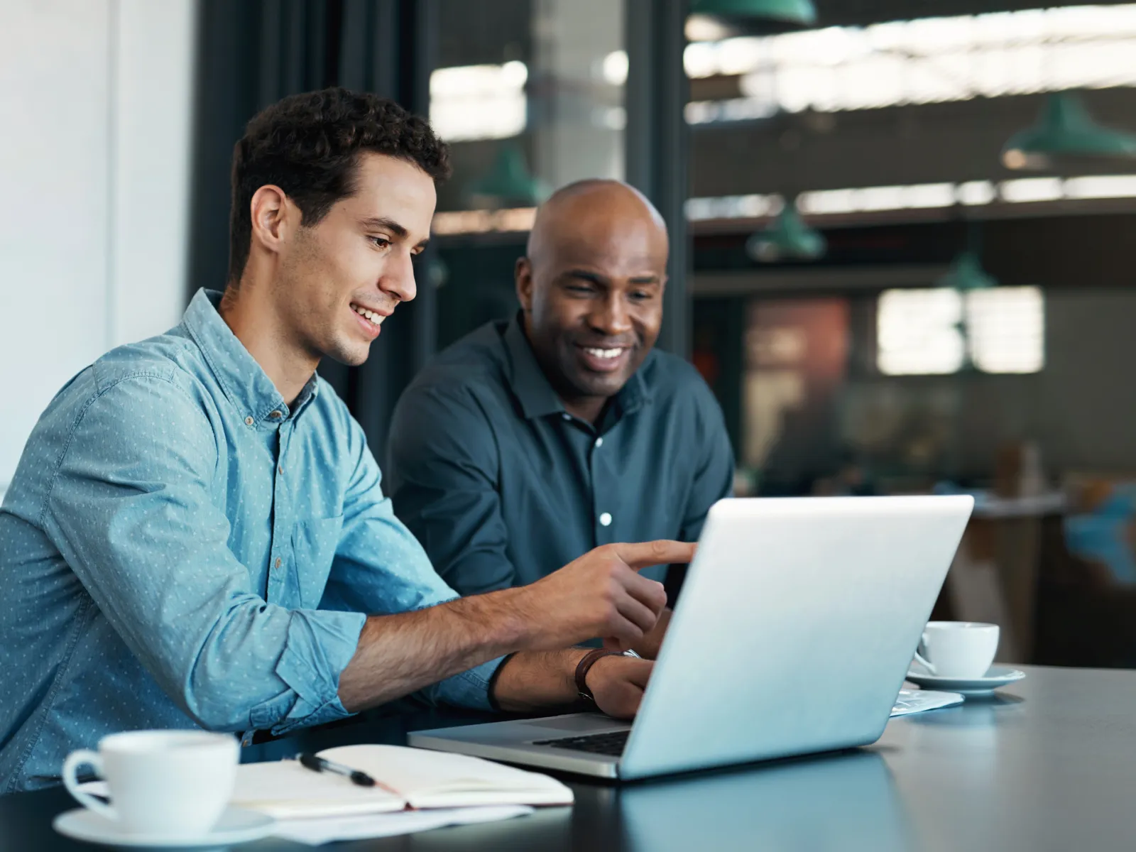 a few men looking at a laptop
