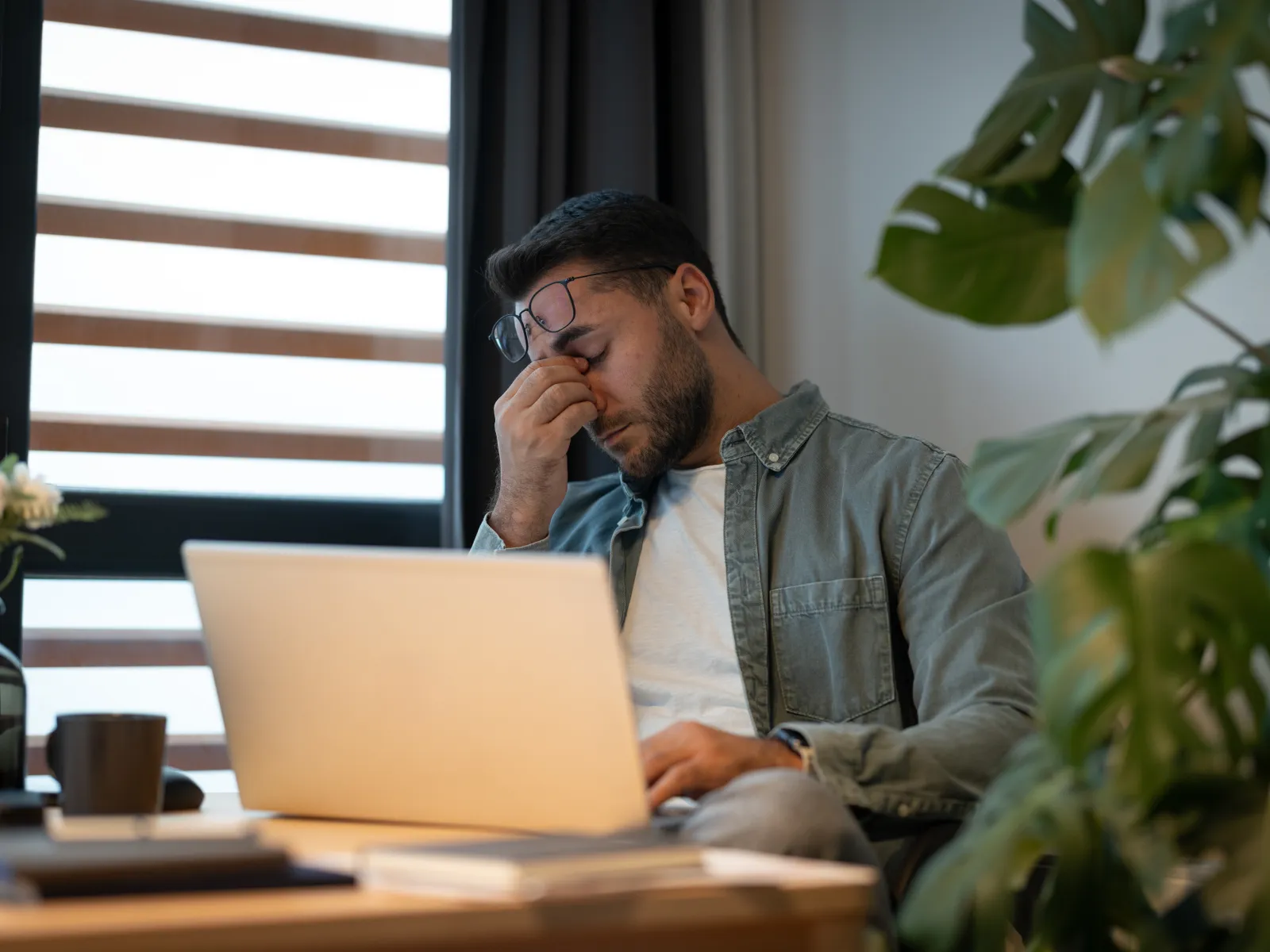 a man sitting at a desk with a laptop