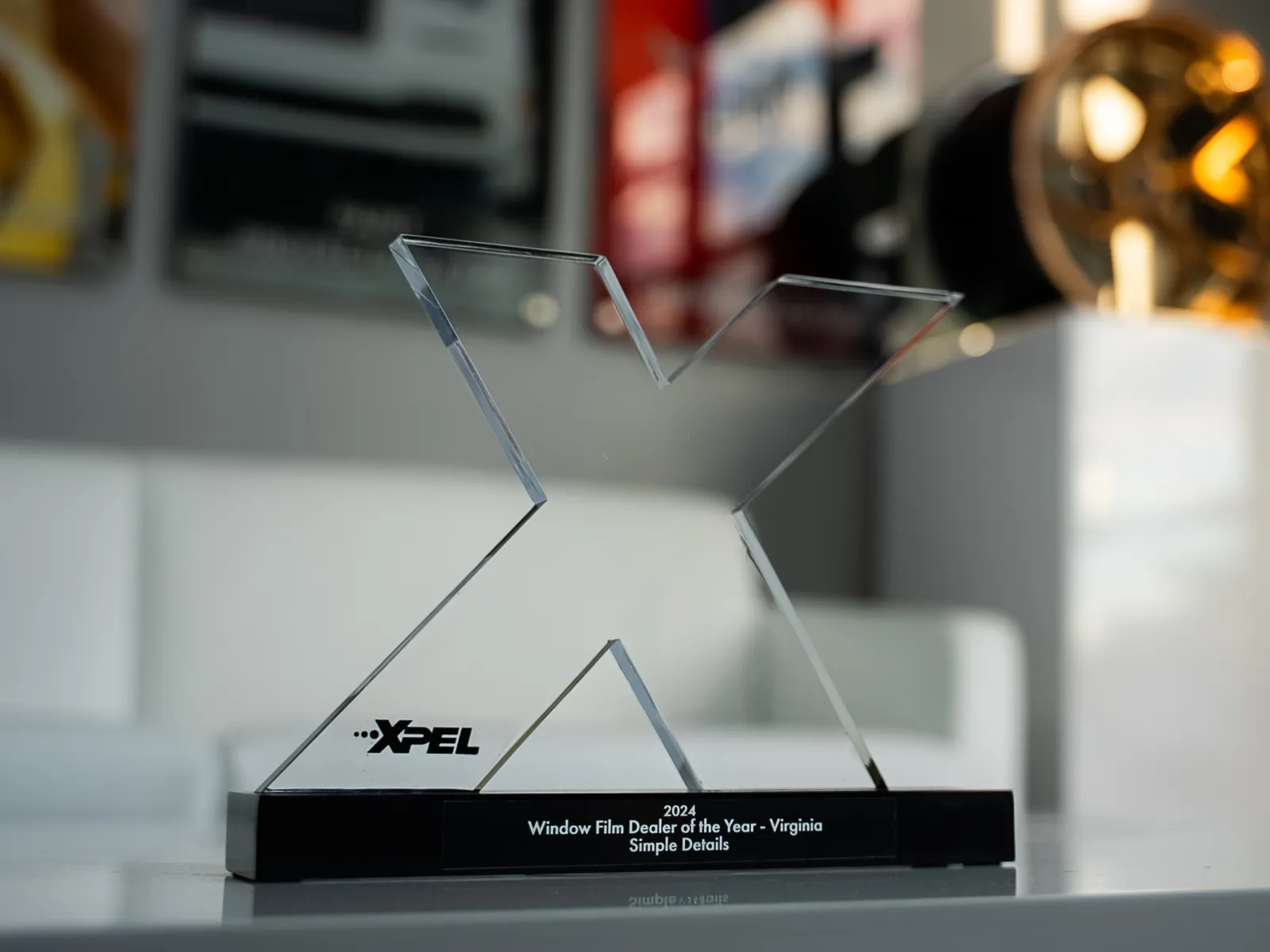 2024 XPEL Window Film Dealer of the Year award for Virginia on a modern white table indoors