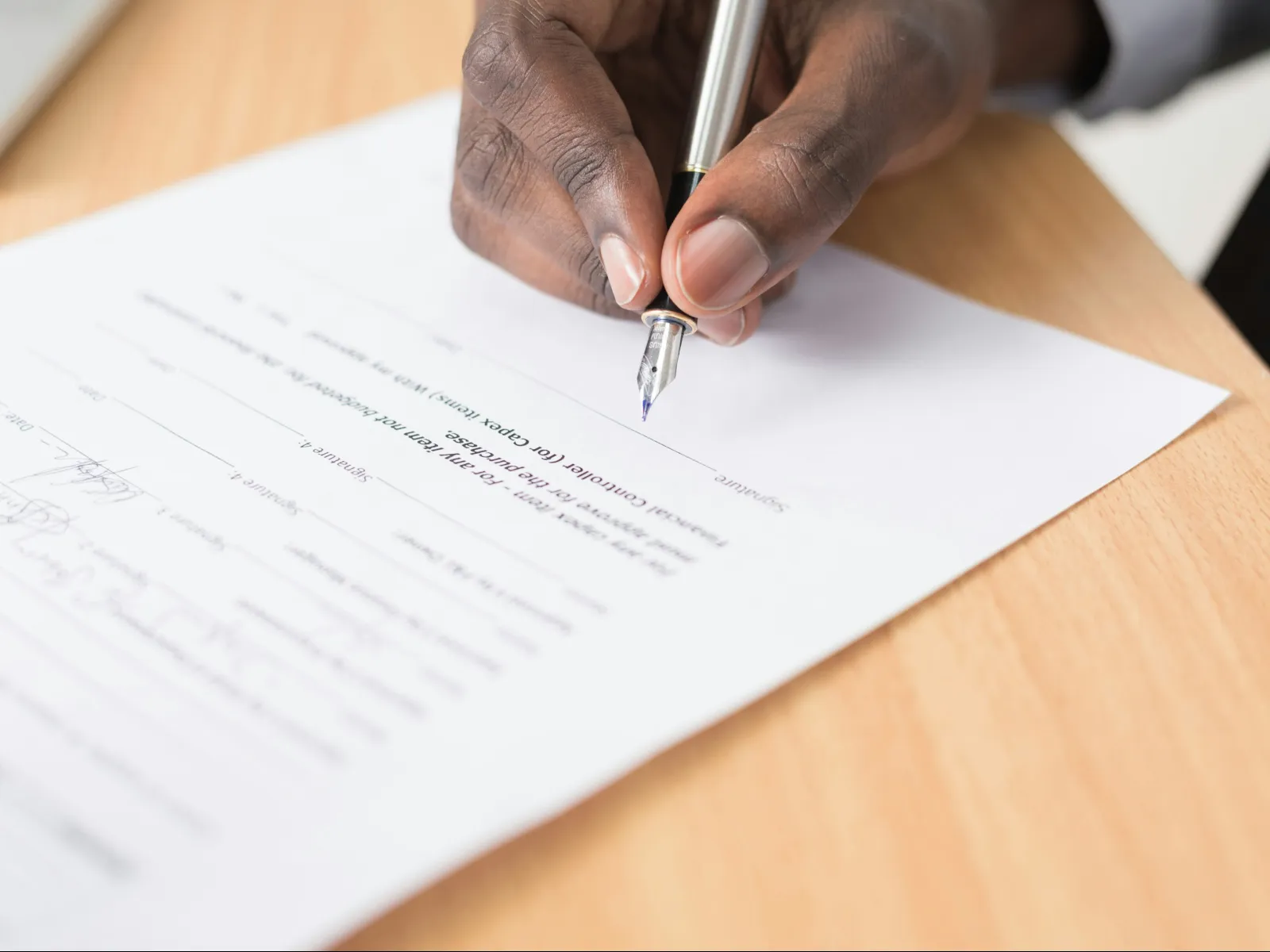 a hand holding a pen