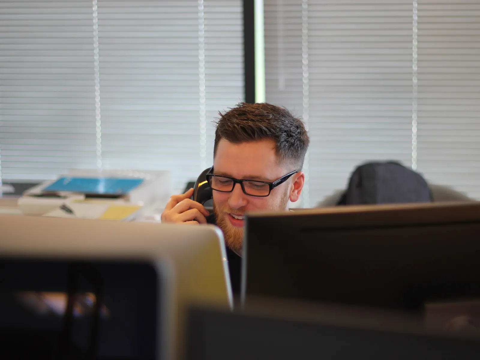 a man on a phone at a desk