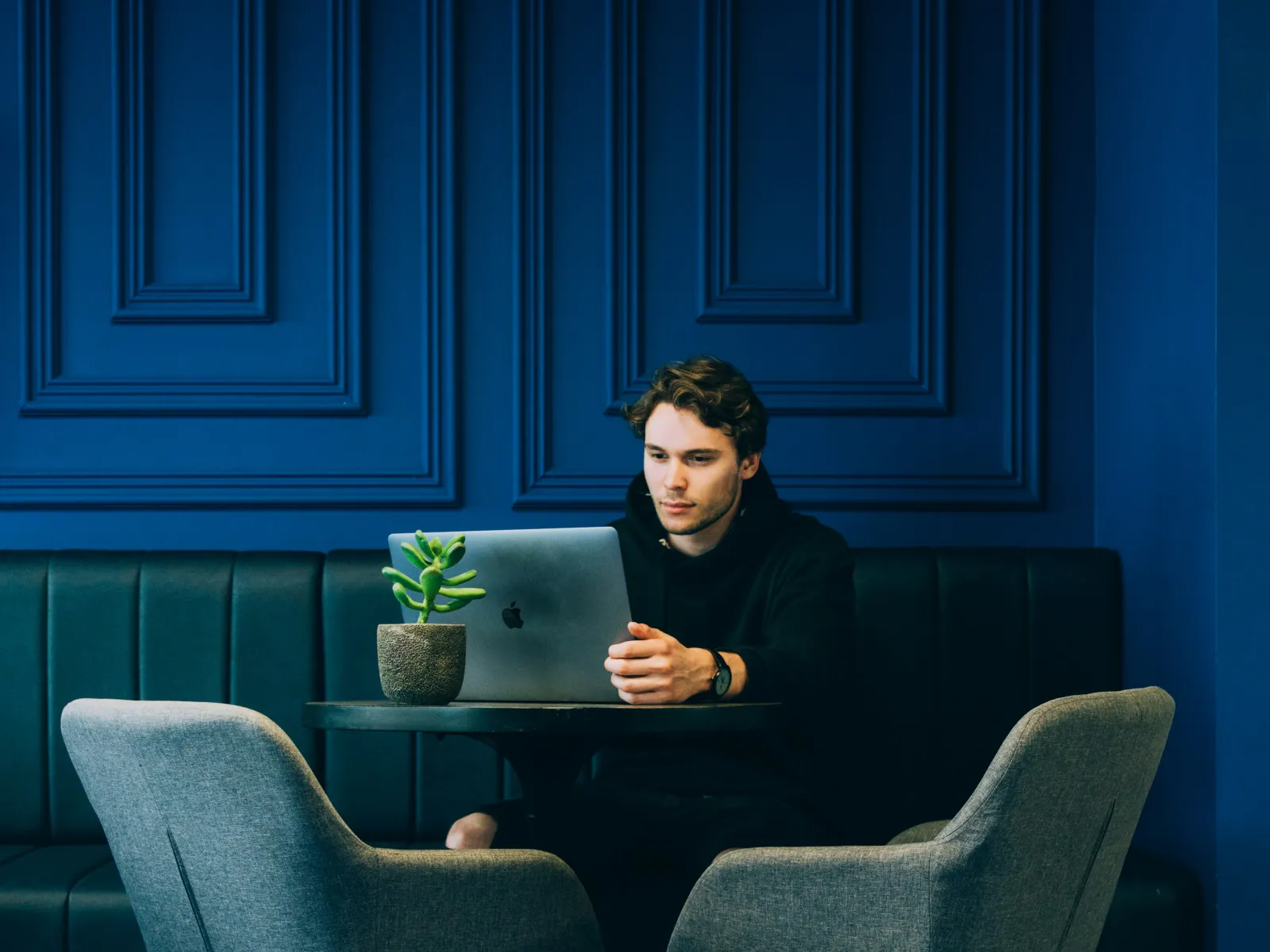 Tamás Lengyel sitting at a table with a laptop