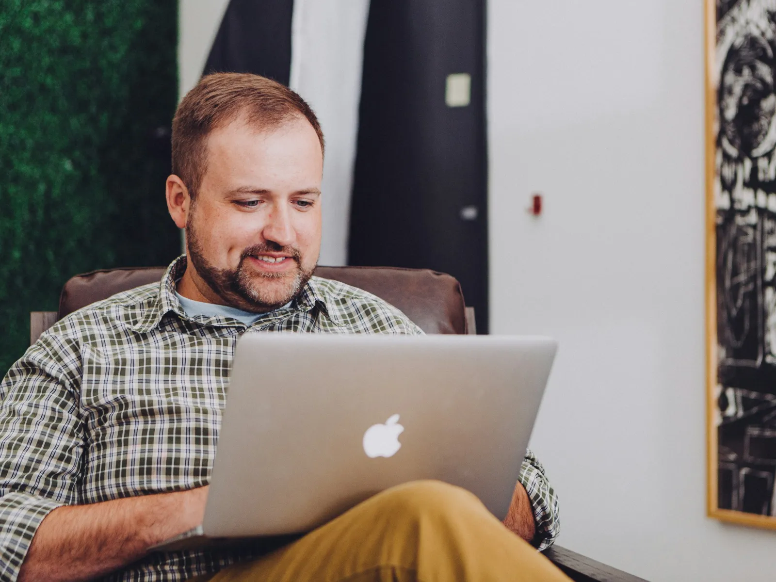a man sitting in front of a laptop