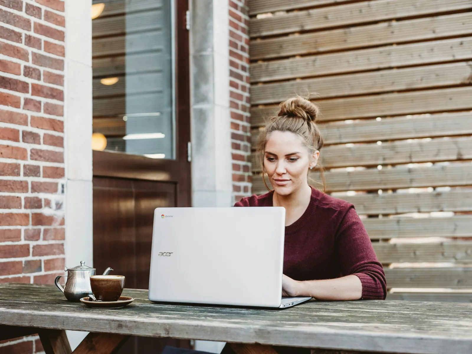 a person sitting at a table with a laptop