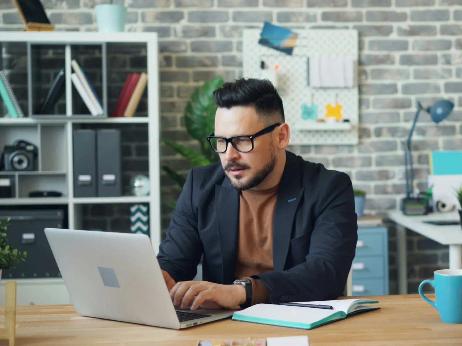 a person sitting at a desk with a laptop