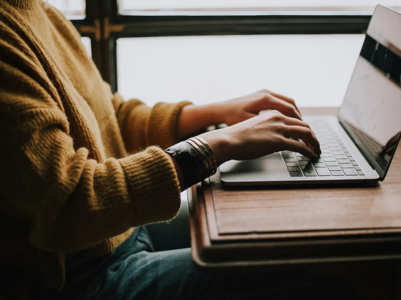 a person typing on a laptop