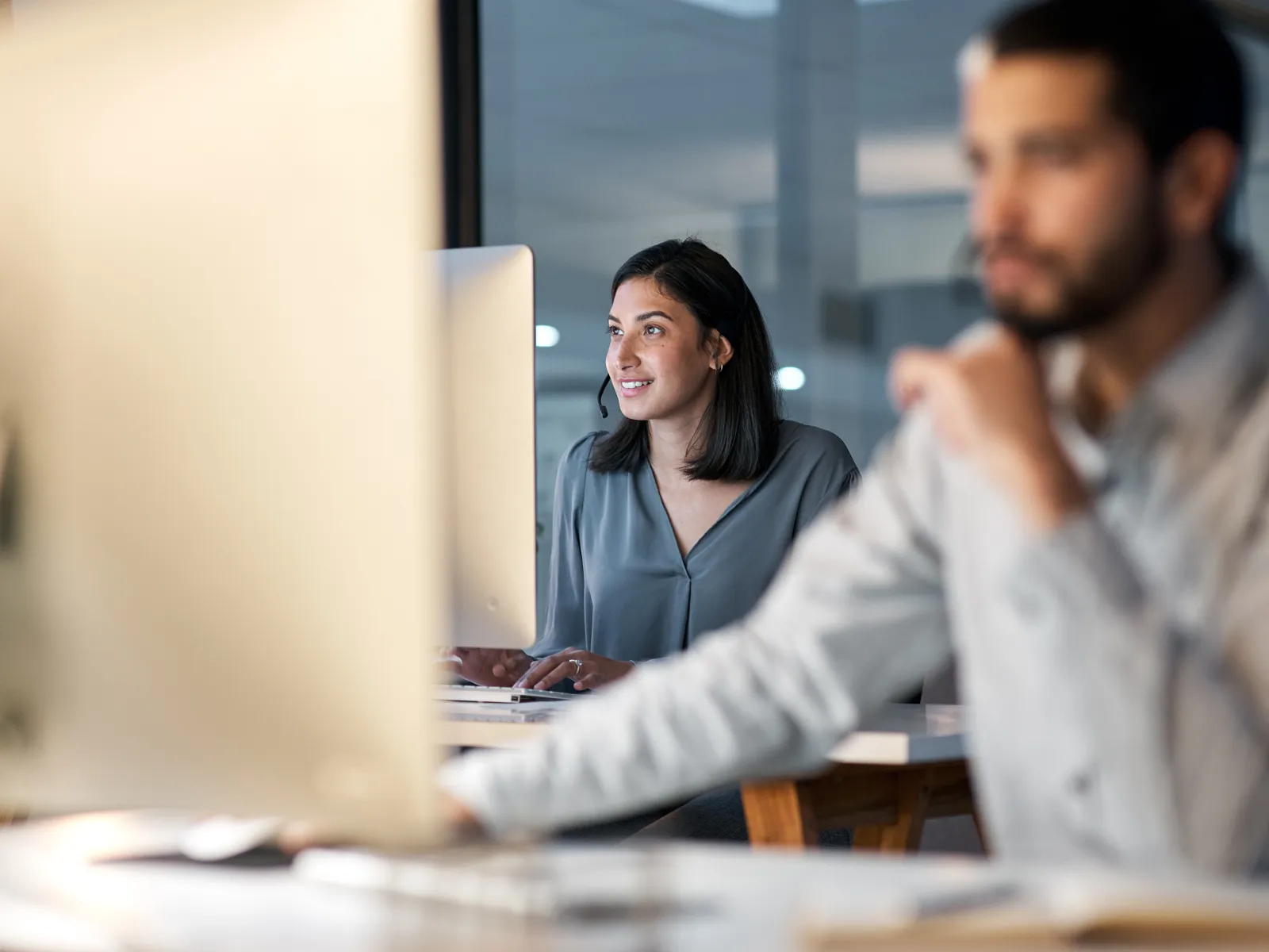 a man and a woman looking at a computer screen