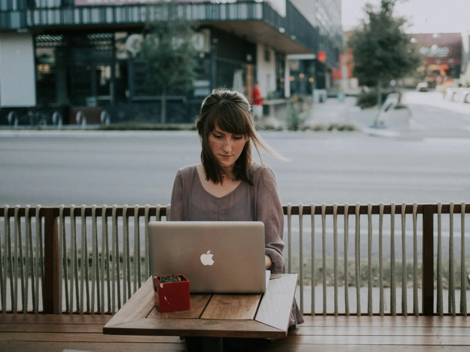 a woman sitting at a table with a laptop
