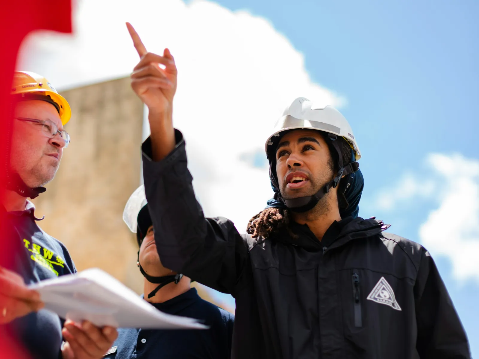 a person wearing headphones and holding up a hand sign