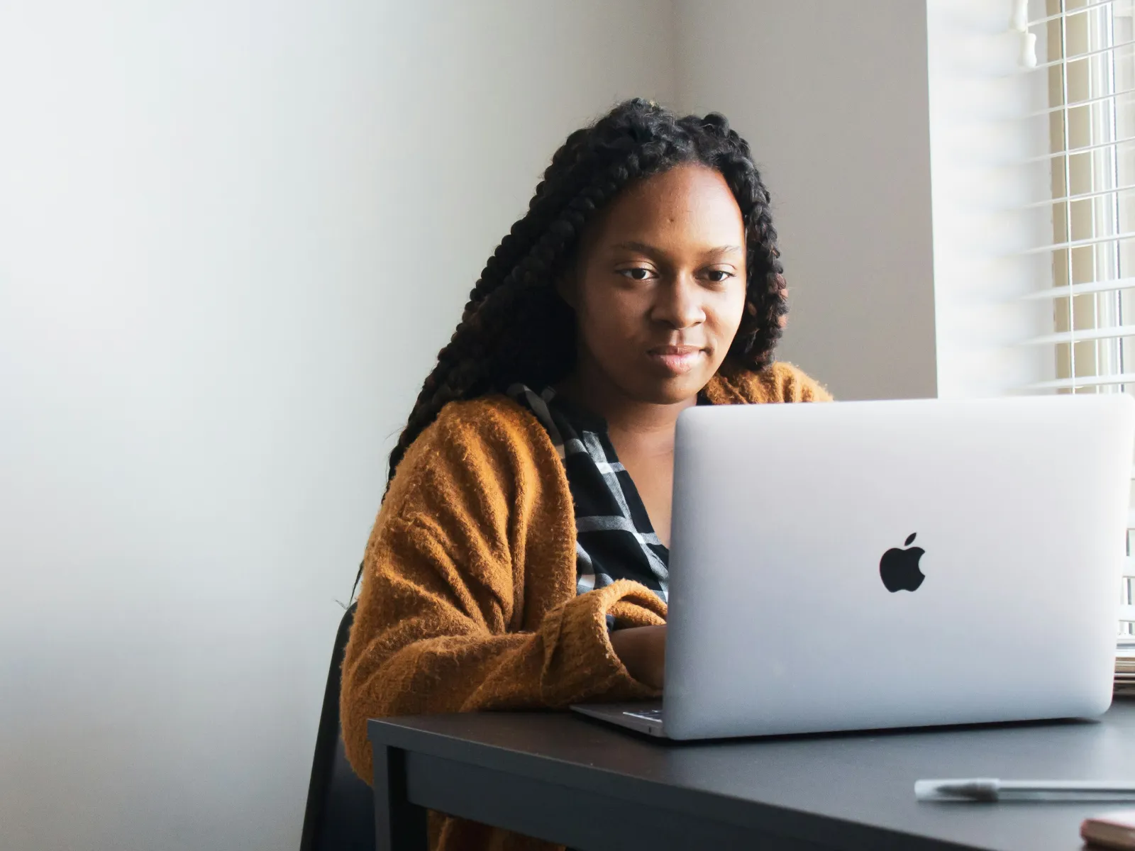 a person sitting at a desk with a laptop