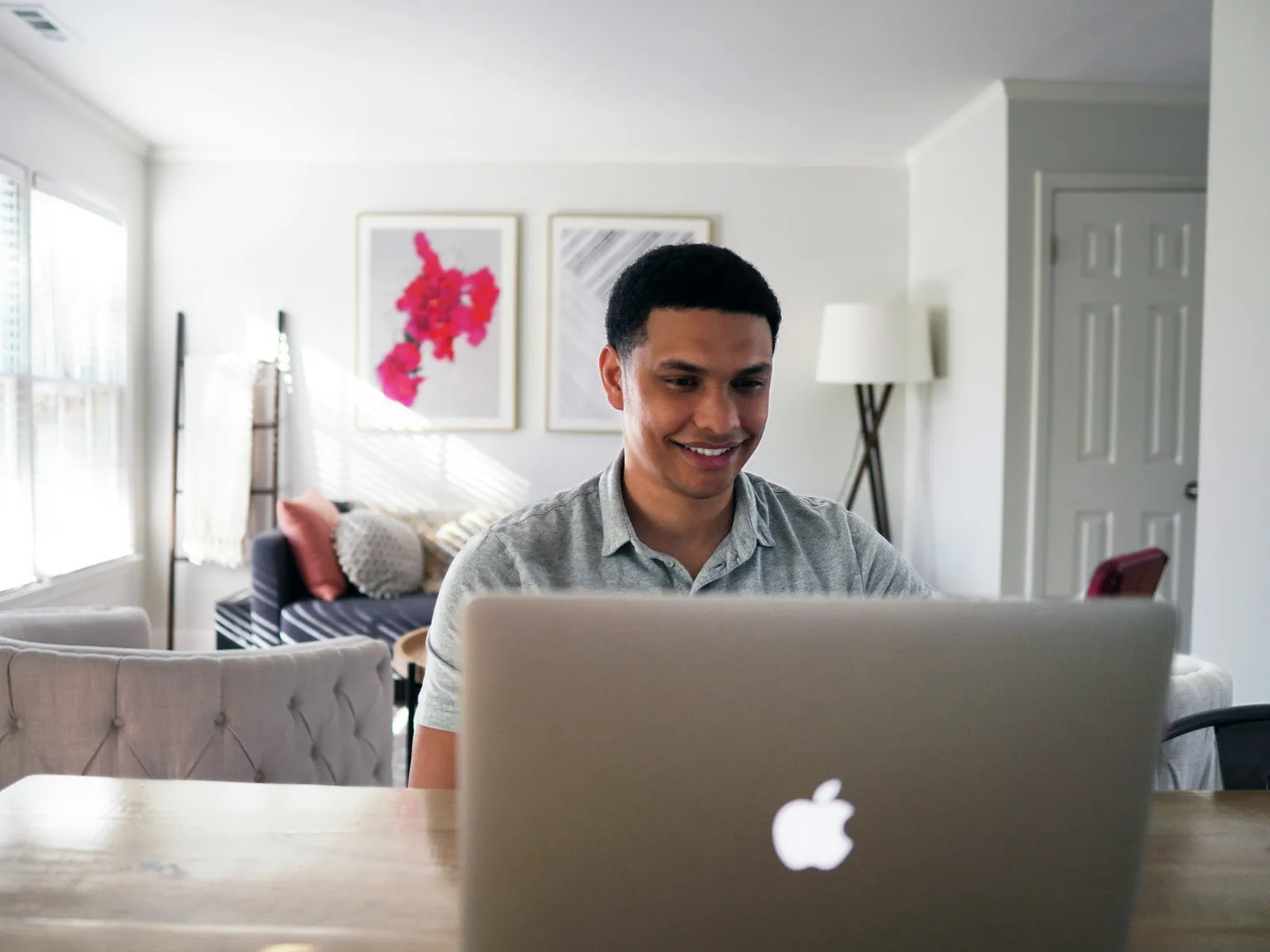 a person sitting at a table with a laptop
