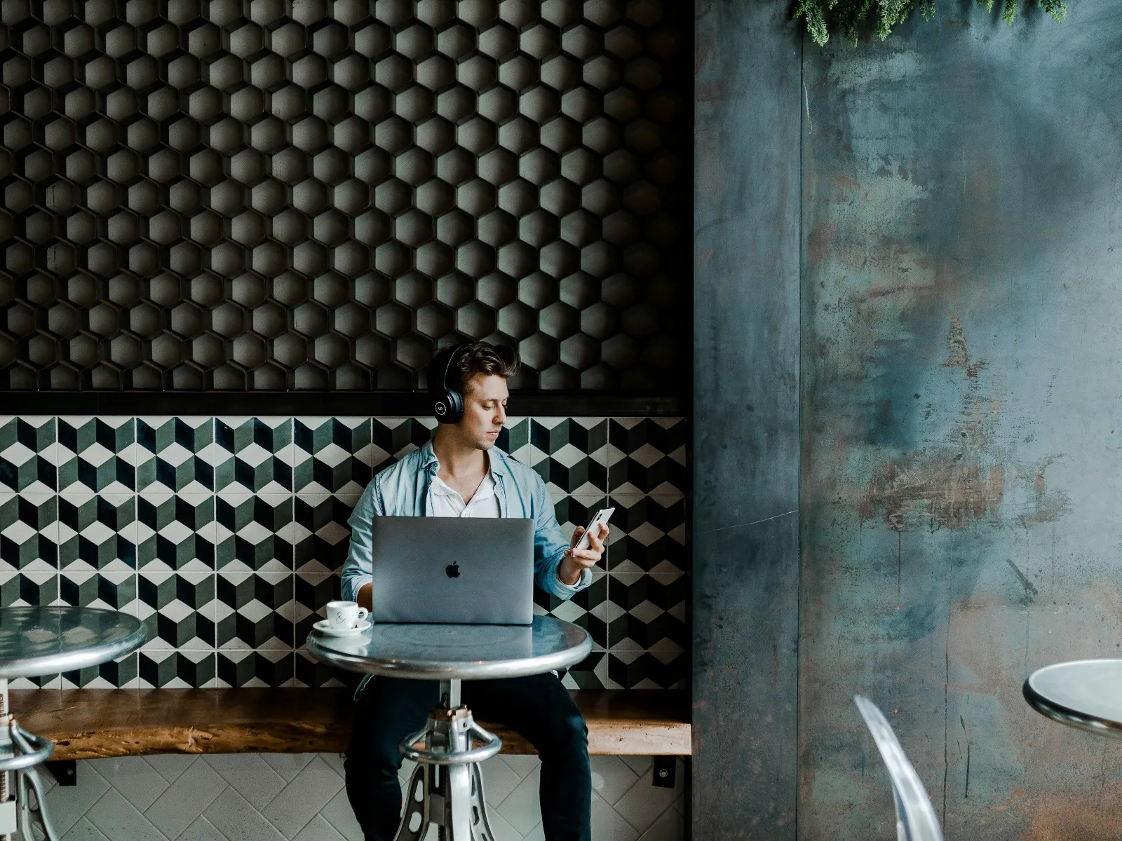 a person sitting at a table with a laptop