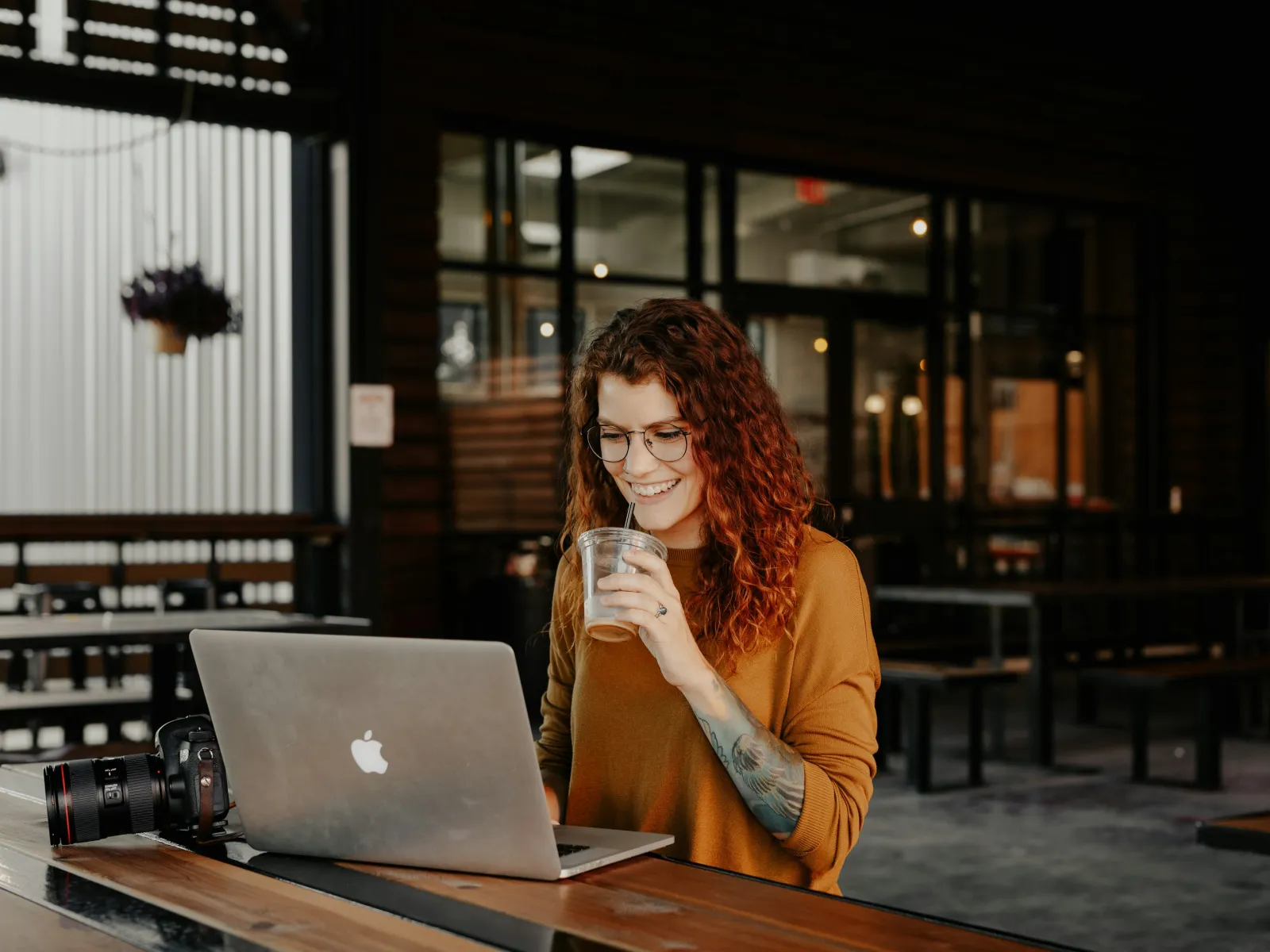a woman sitting at a table with a laptop