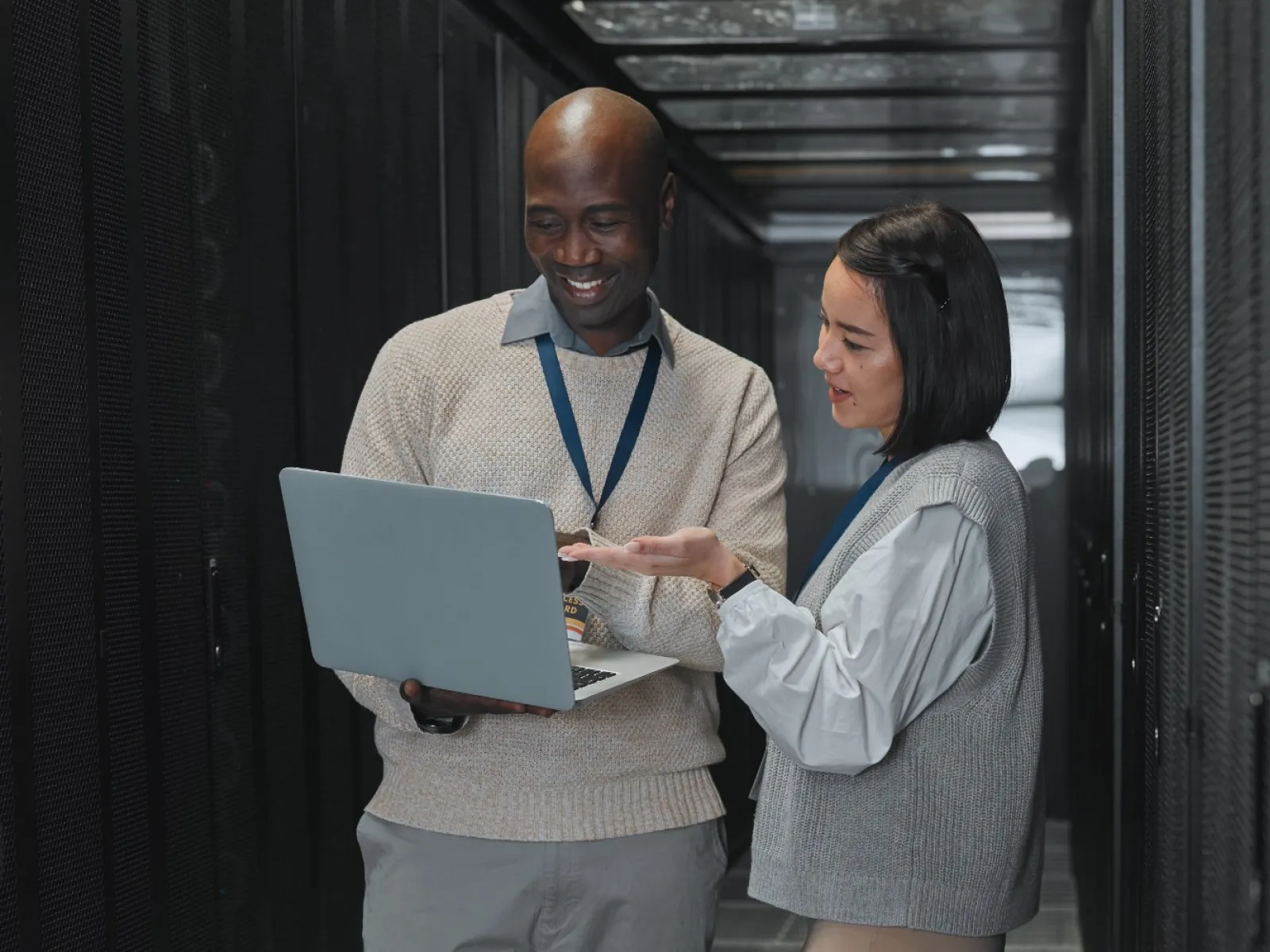 a man and a woman looking at a laptop