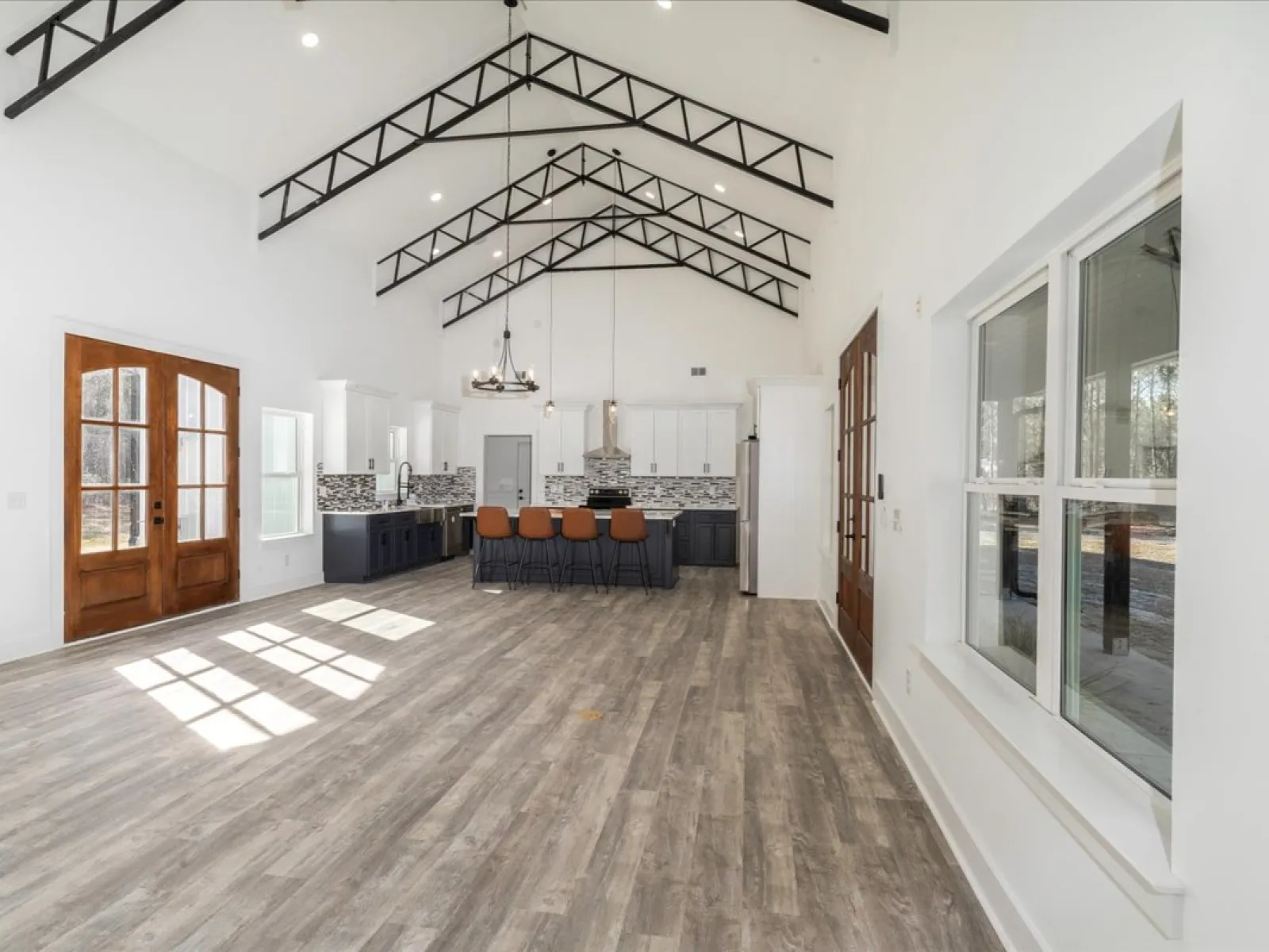 a large white room with a wood floor and a wood floor