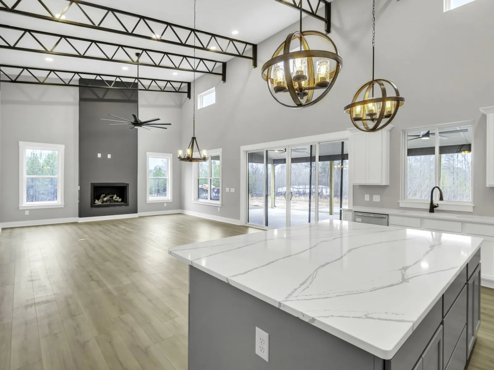 a large kitchen with a large white countertop and a large chandelier