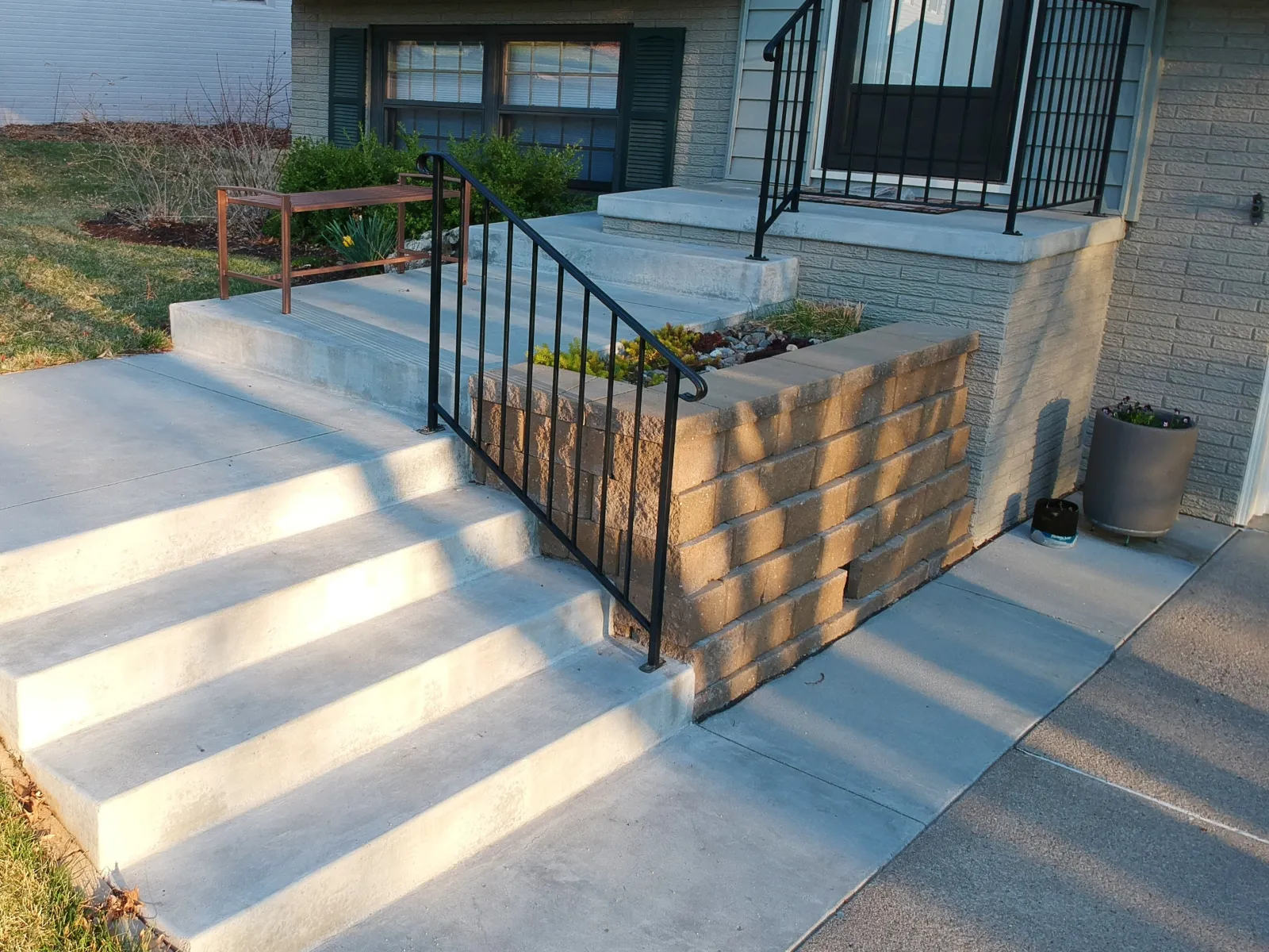 a deck with a fence and plants
