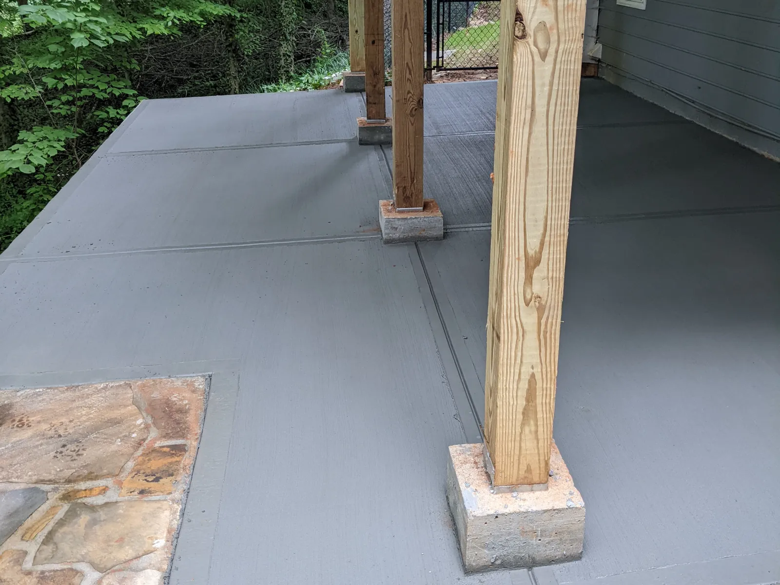 a stone patio with a wood door