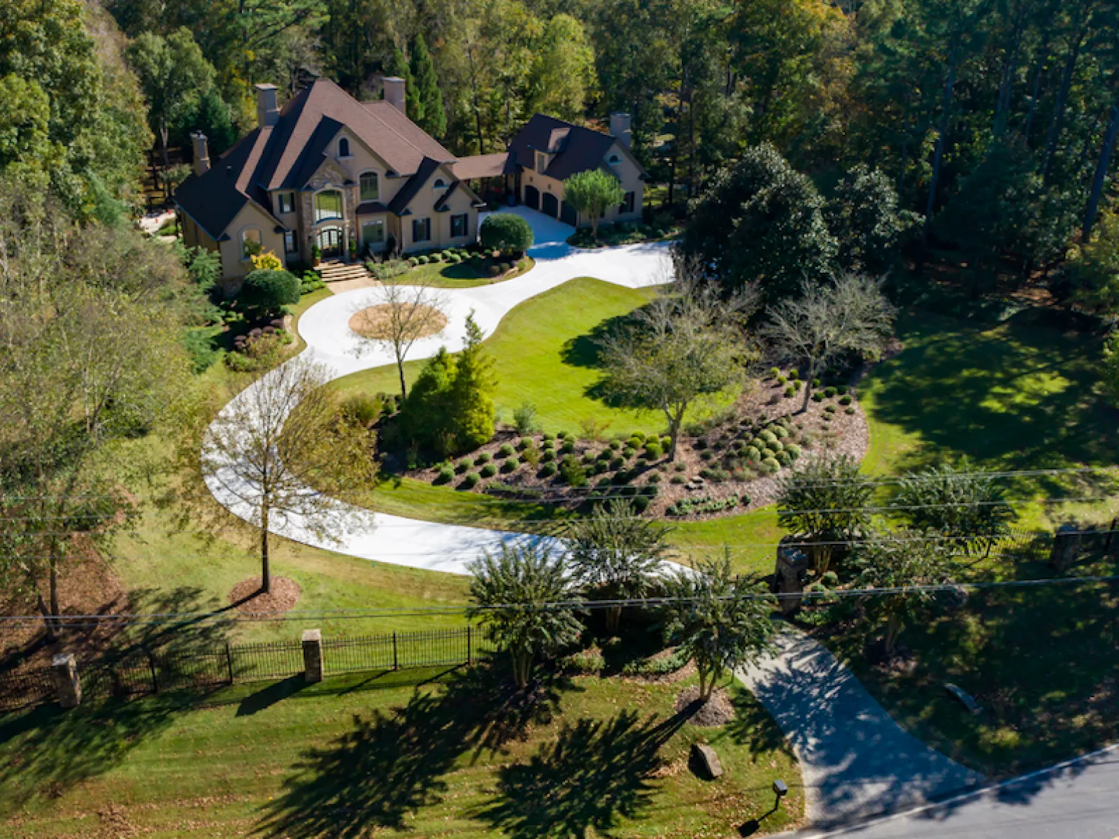 a house with a pond and trees around it