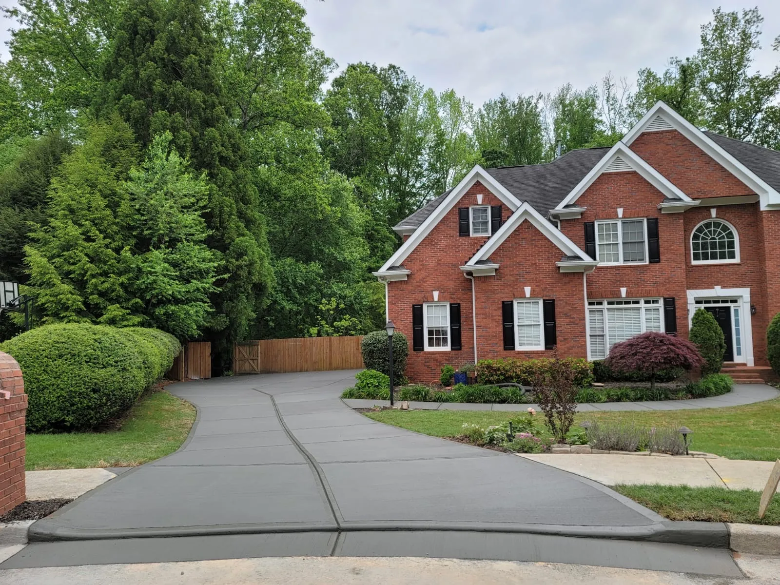 a house with a driveway and trees