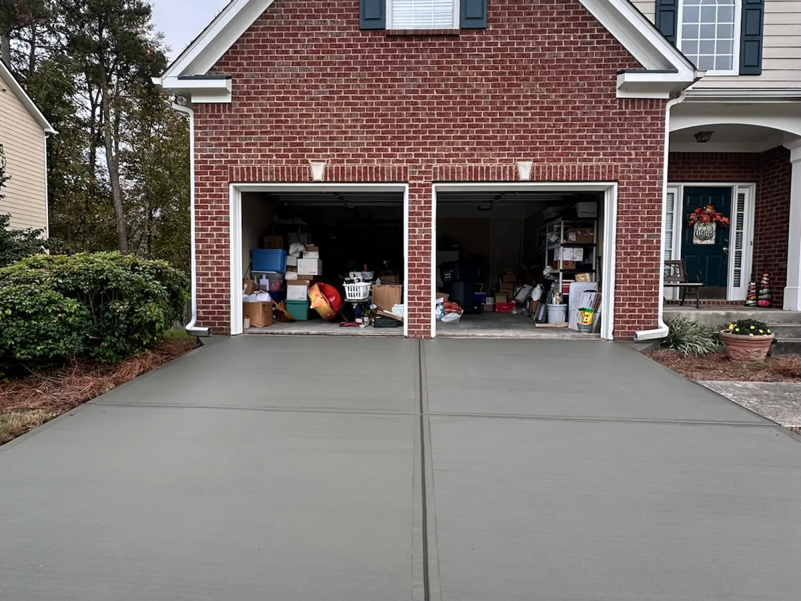 A two-car garage featuring a clean concrete driveway and organized storage inside.