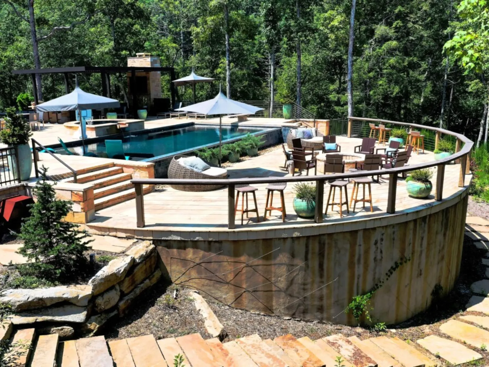 a pool with chairs and tables next to it