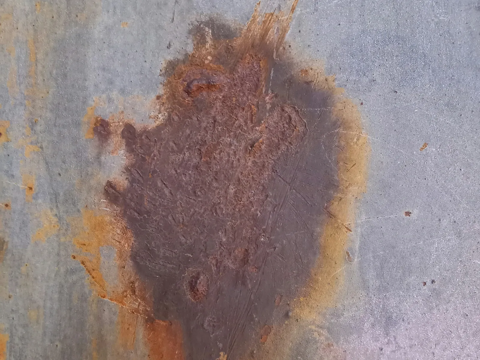 Concrete steps leading to a landscaped hill with stone retaining wall and manicured lawn, showcasing outdoor design.