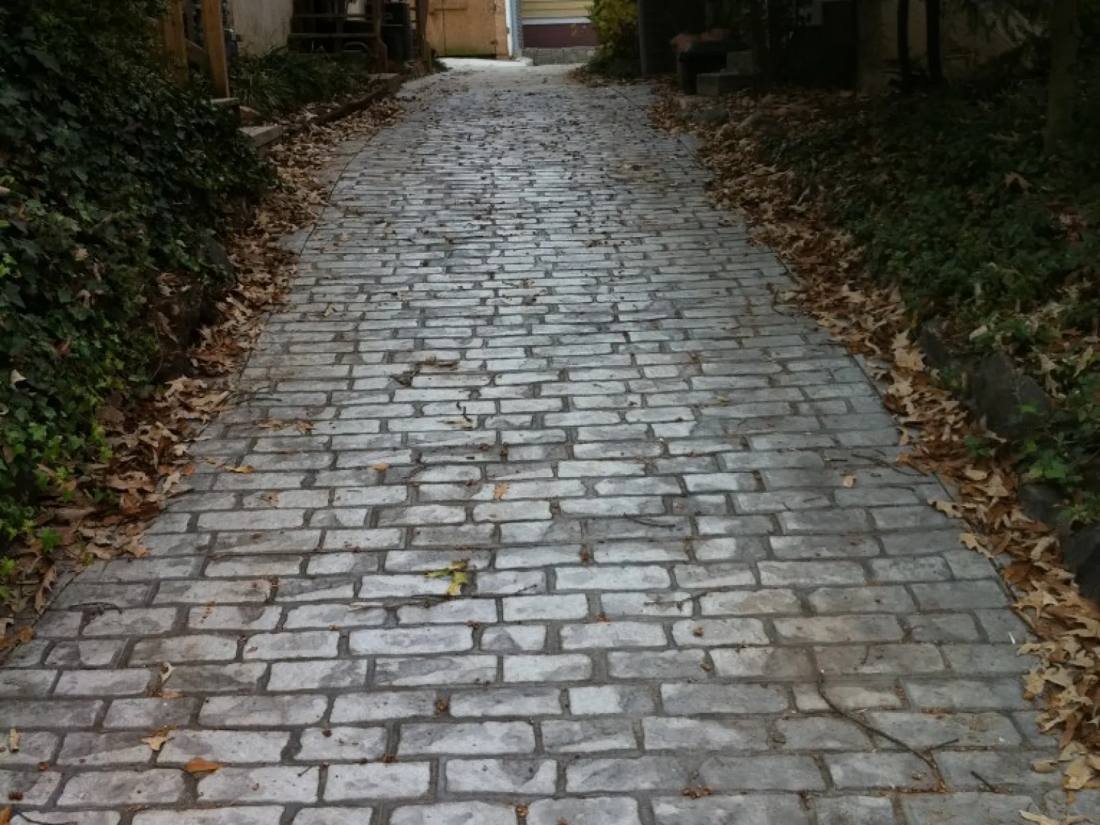 a cobblestone road with houses on either side of it