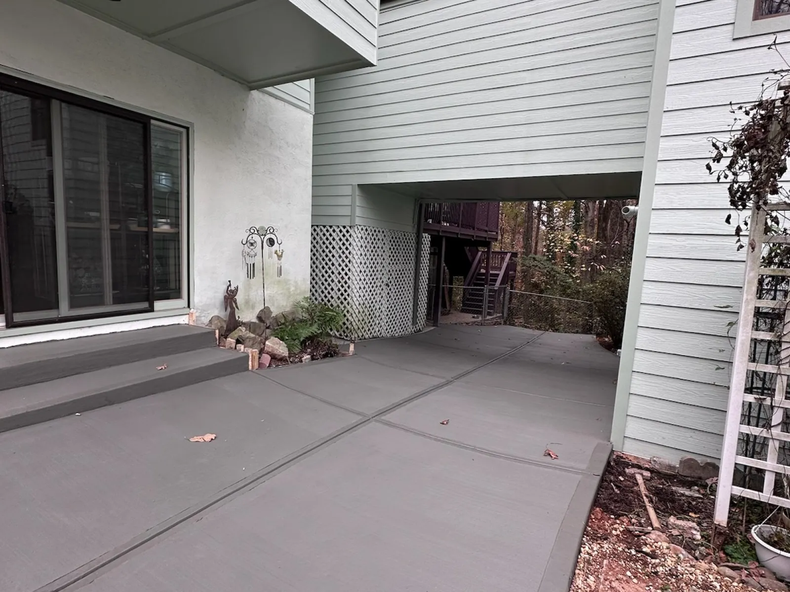 a house with a garage and a dog sitting on the porch