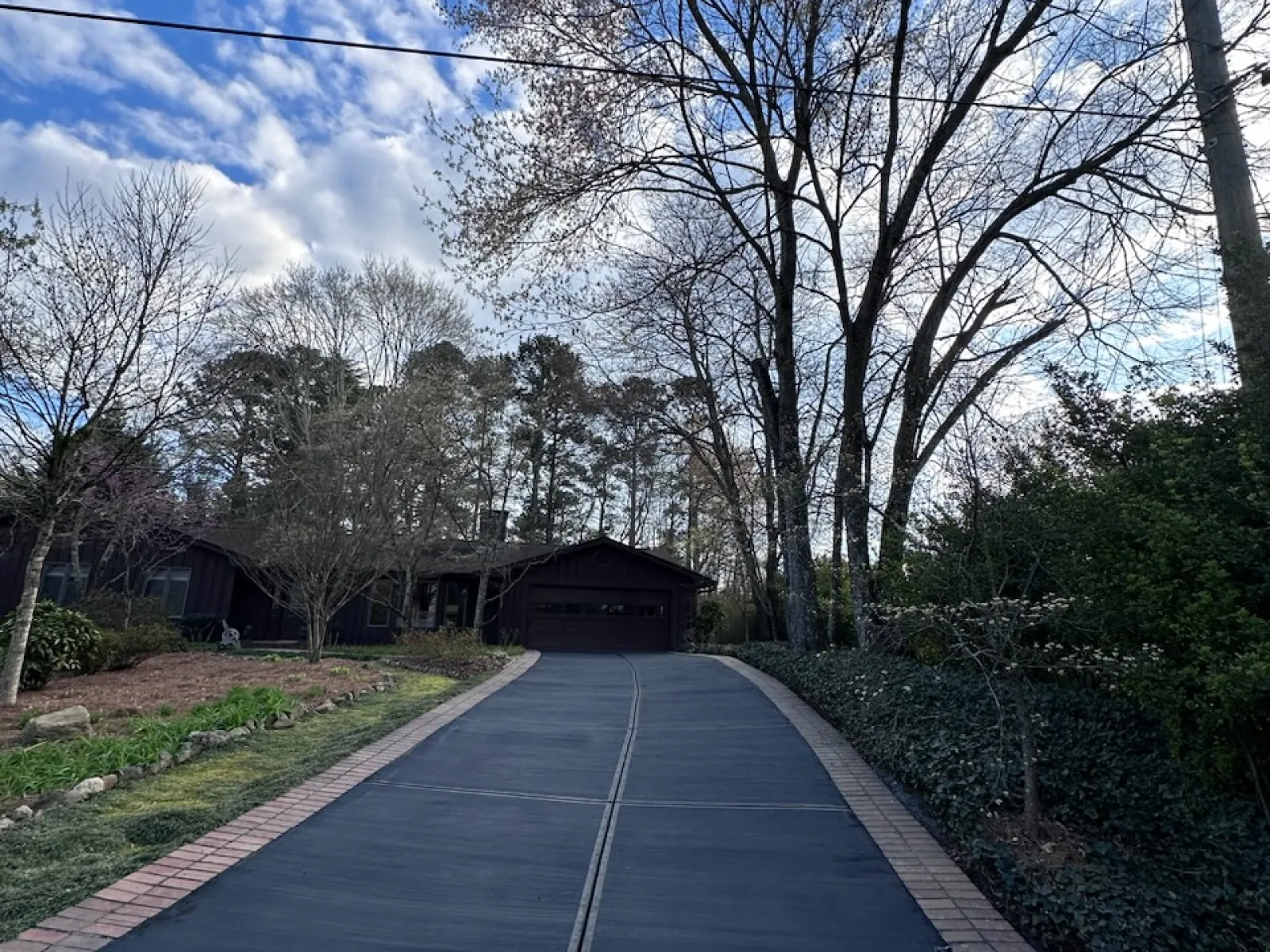 a paved road with trees on either side of it