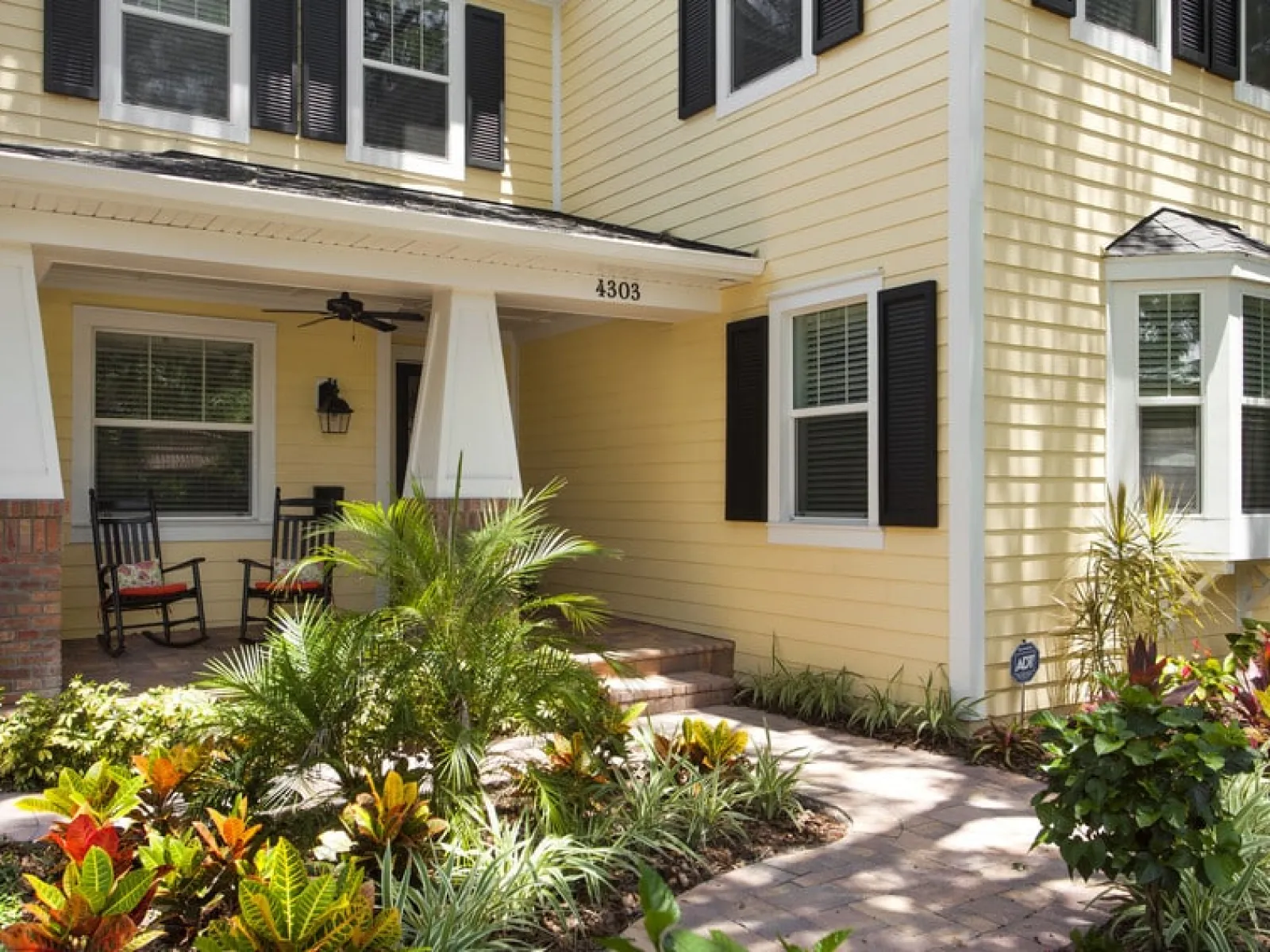 yellow house with black shutters