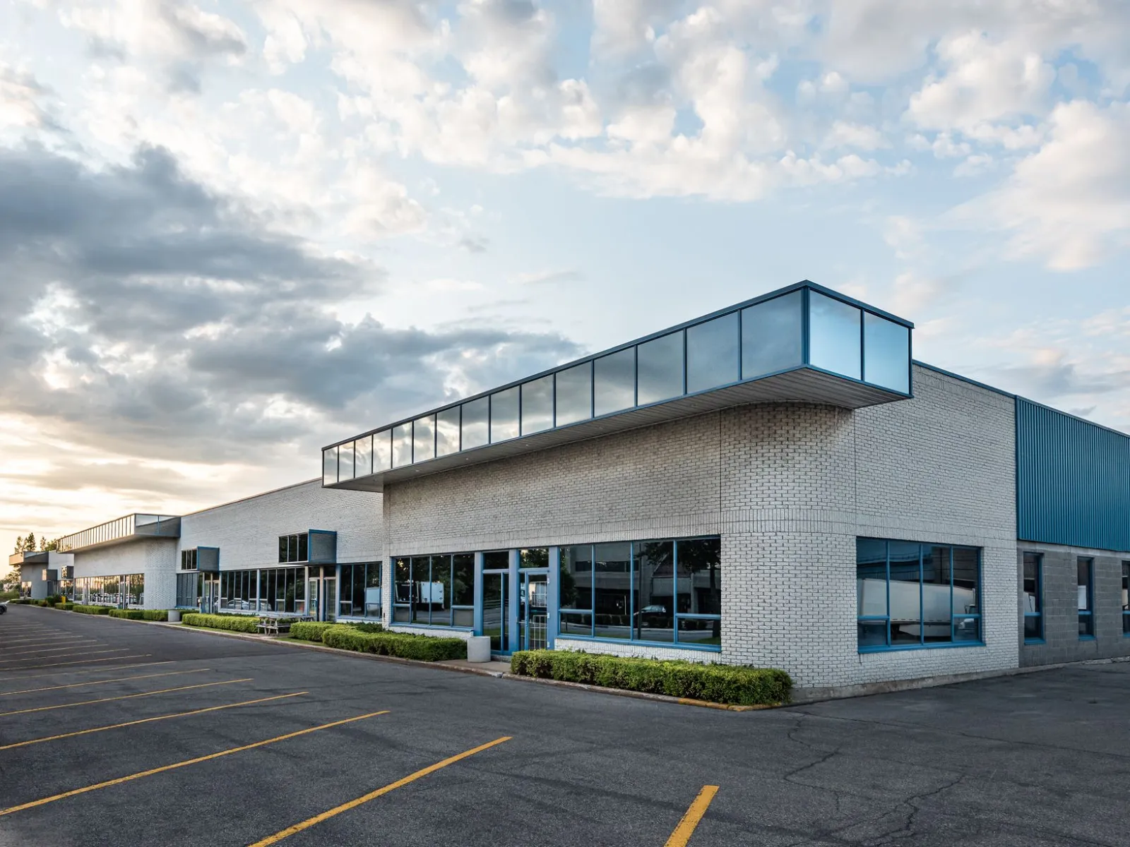 a large empty parking lot in front of a building