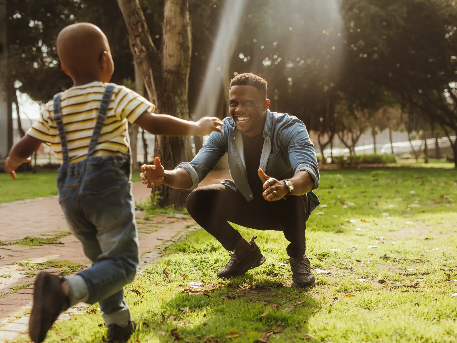 a little boy running to hug his dad