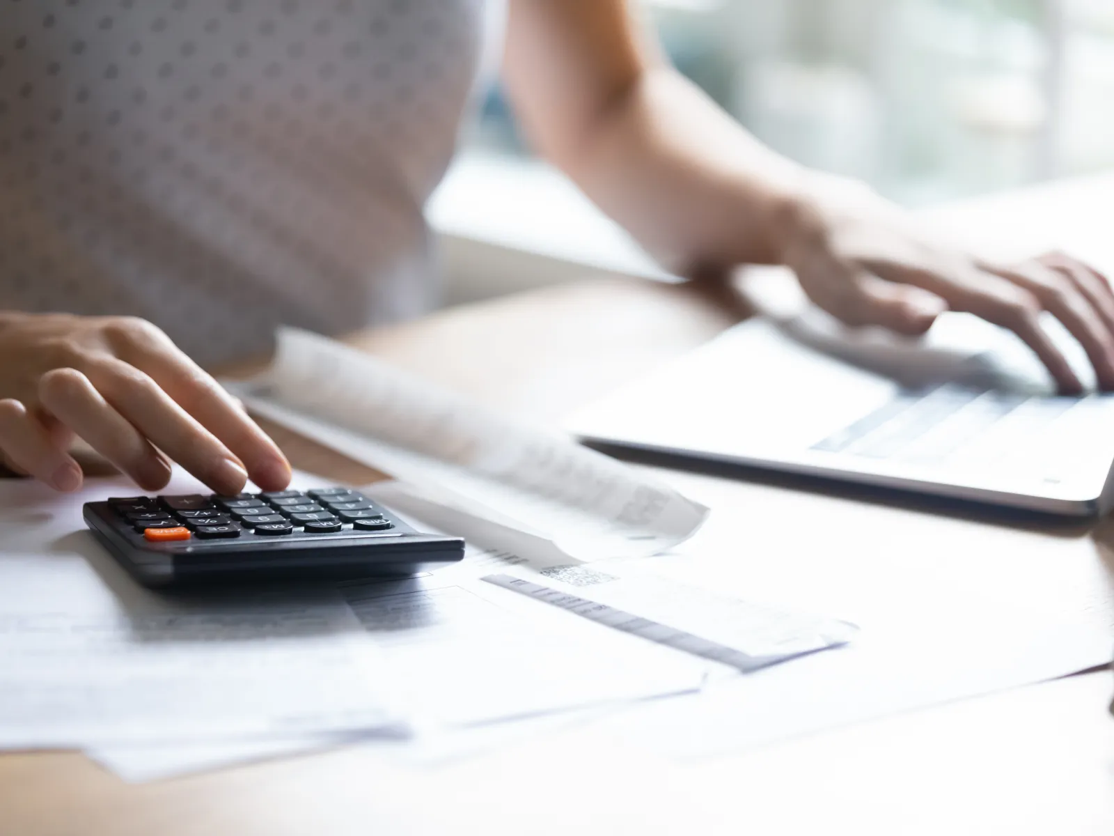 a person using a calculator while doing their bills