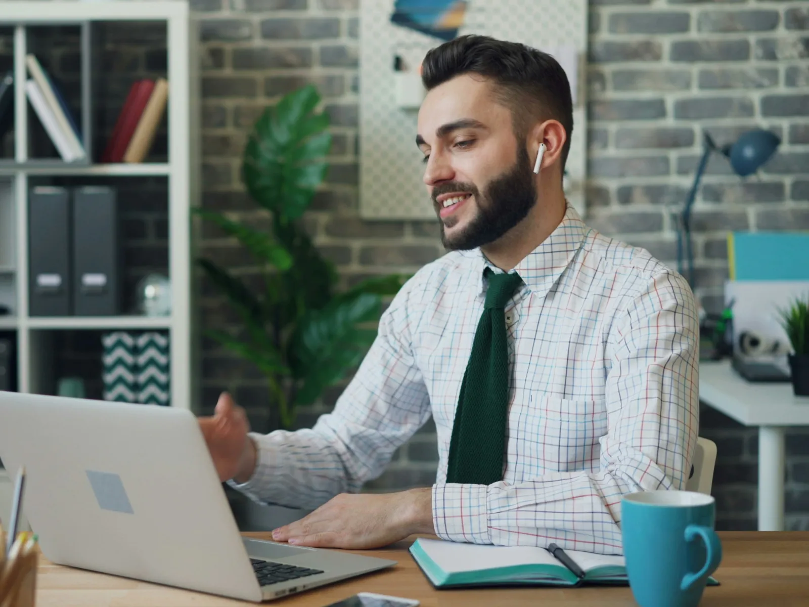 a man sitting at a table with a laptop