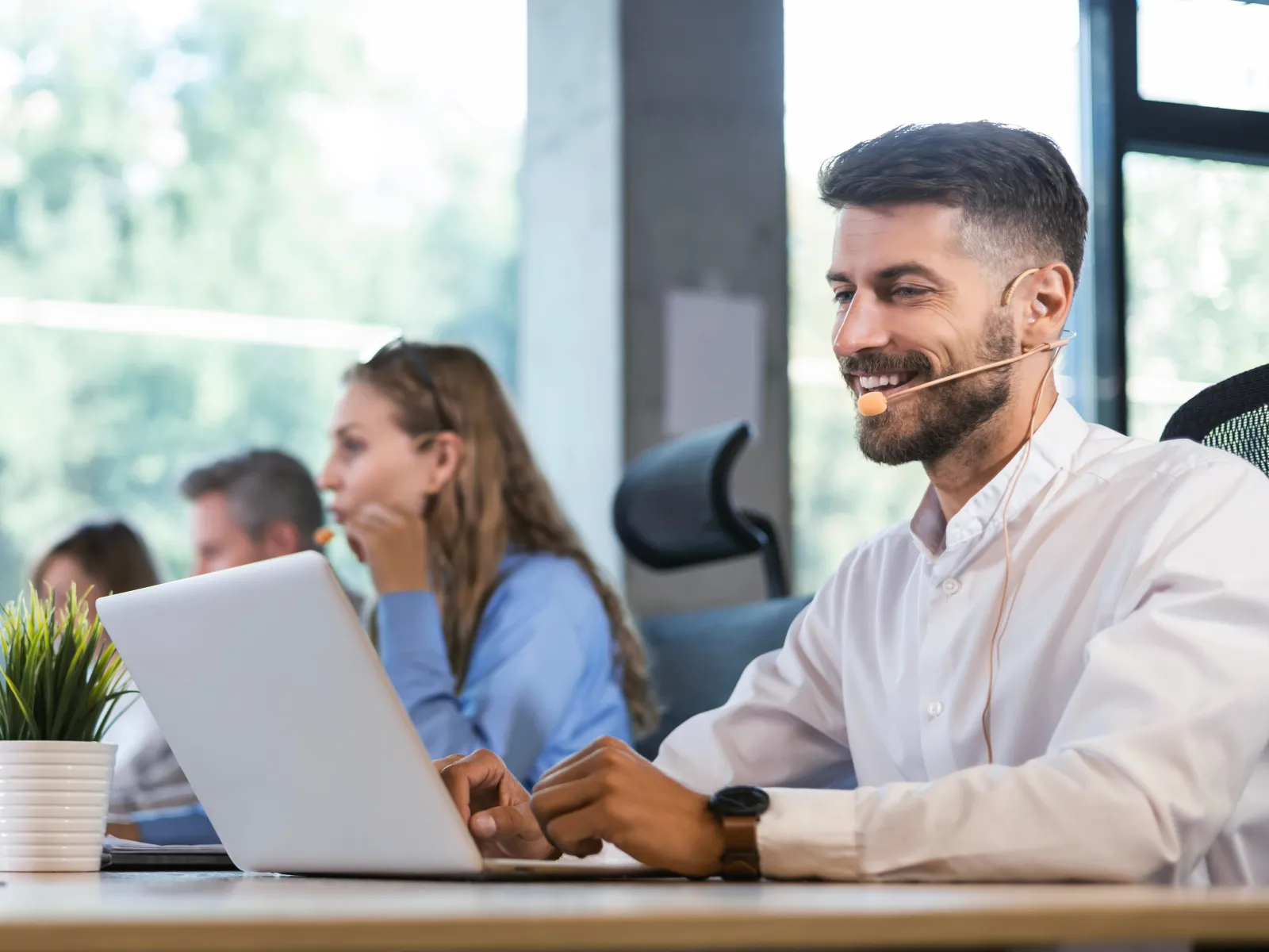 a man and a woman looking at a laptop