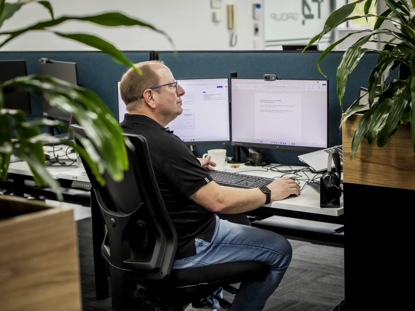 a man sitting at a desk with a computer