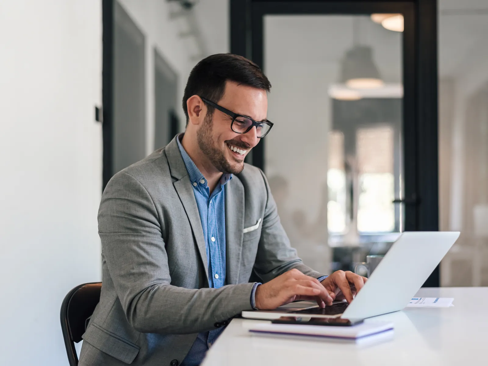 a man sitting at a table with a laptop