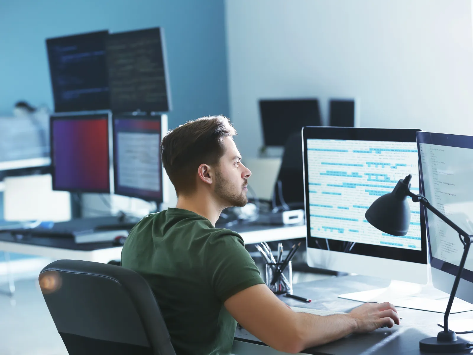 a person sitting at a desk with a computer