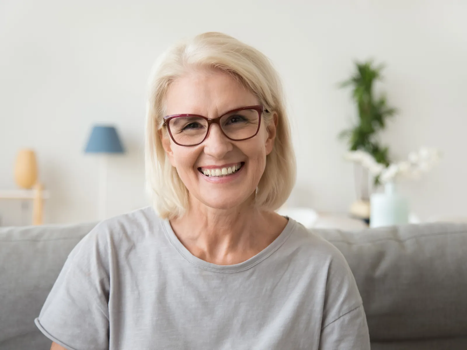 a woman smiling on a couch