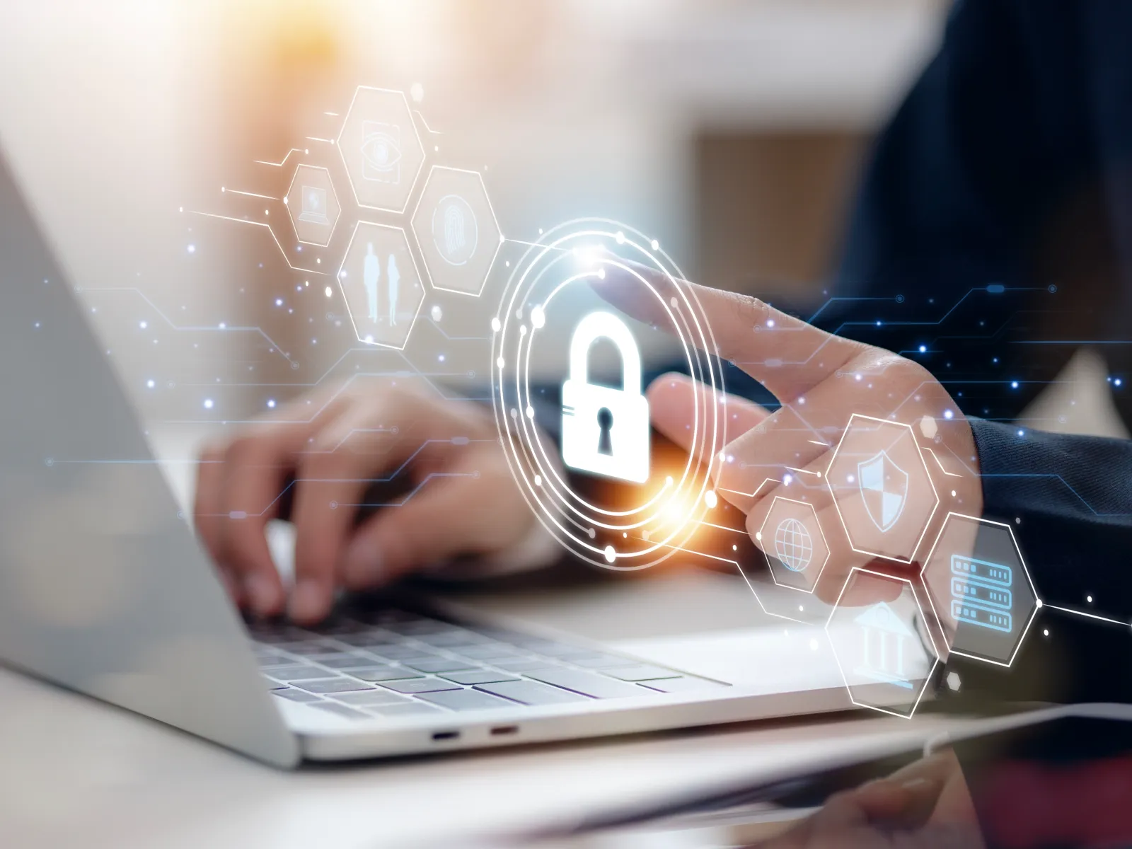 Person using laptop with digital padlock icon representing cybersecurity and data protection.