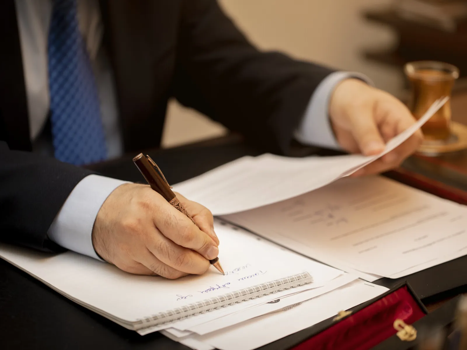 a person writing on a piece of paper