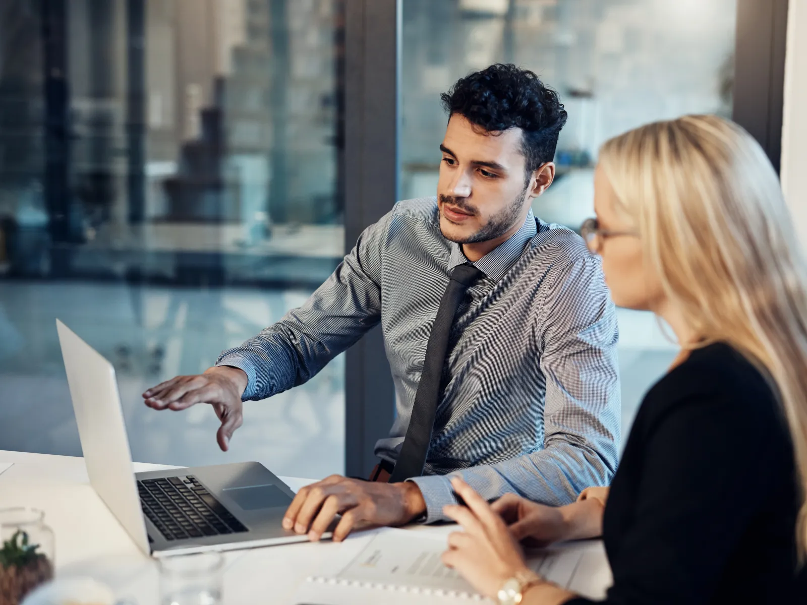 a man and a woman looking at a laptop
