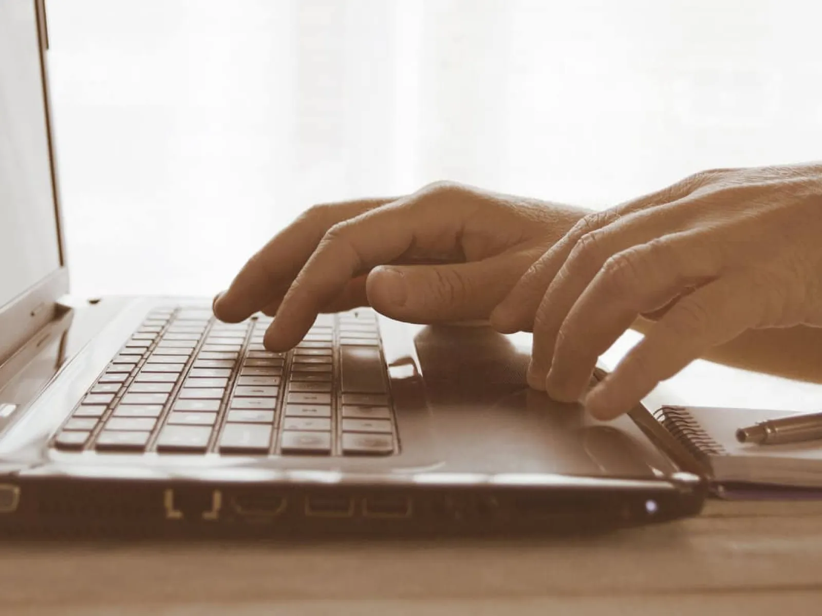 a person typing on a laptop