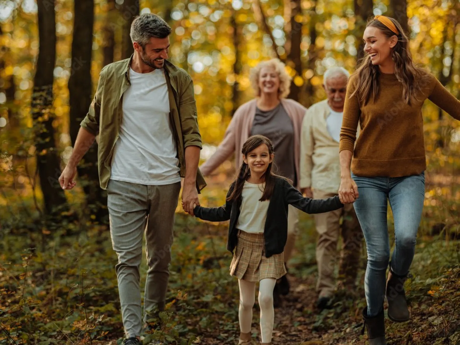 a group of people walking in the woods