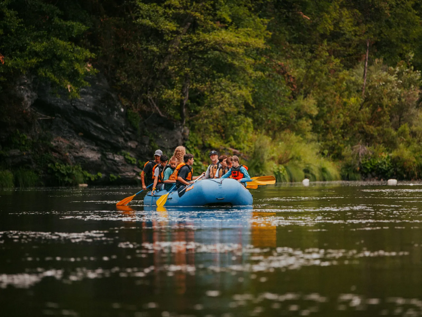 a group of people in a canoe on a river