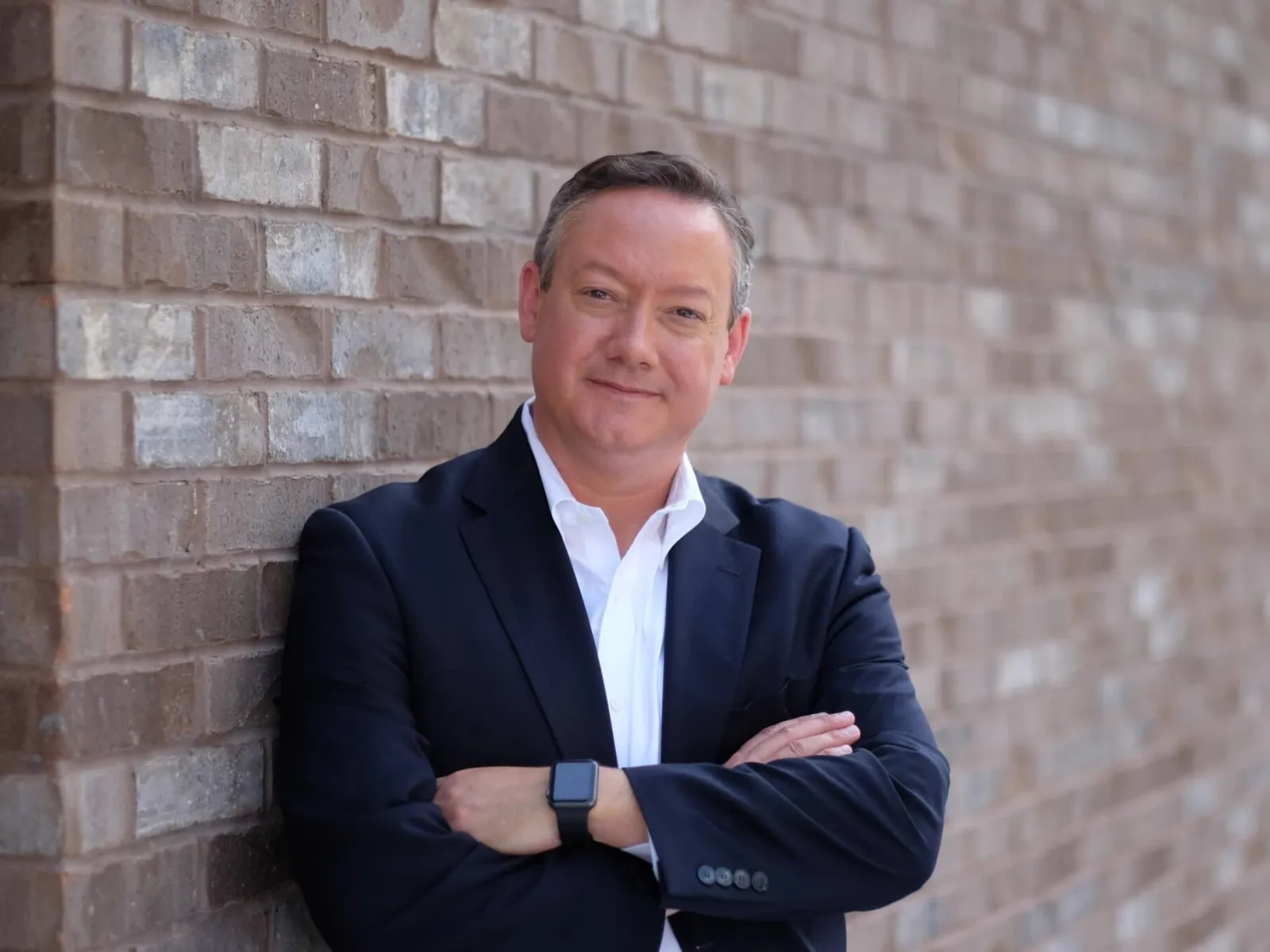 a man leaning against a wall