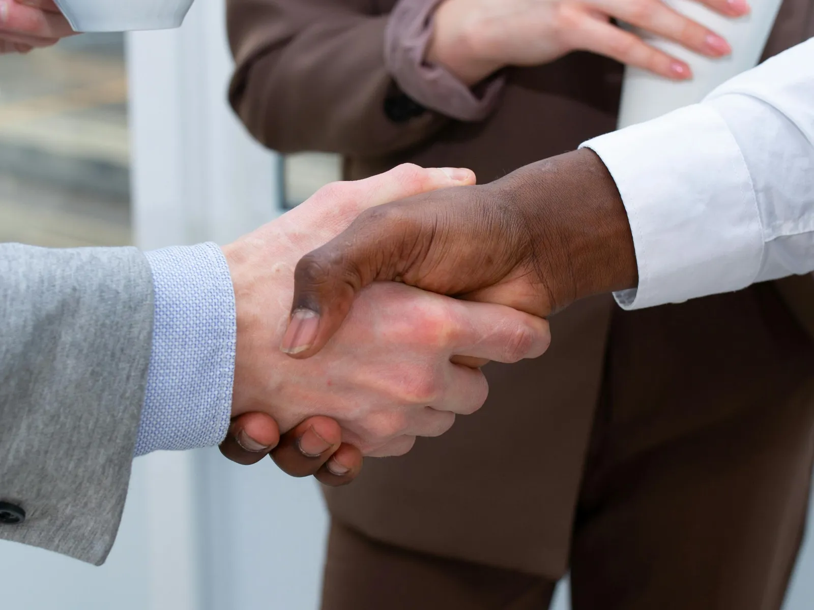 a close-up of hands shaking