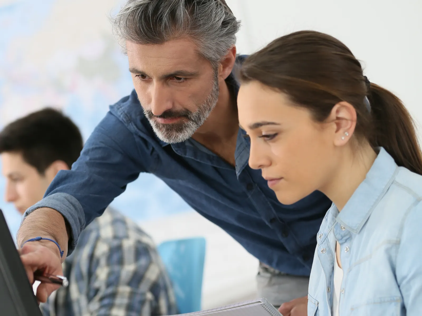 a man and a woman looking at a computer screen