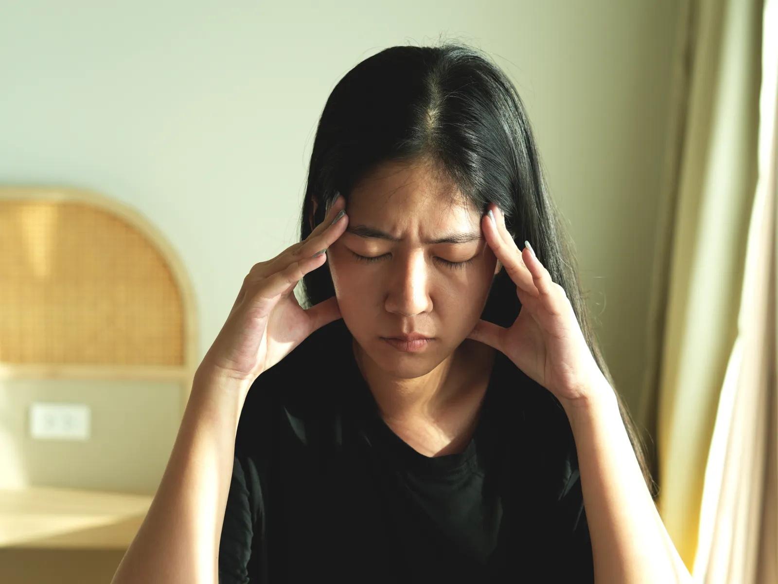 a woman with her hands on her face
